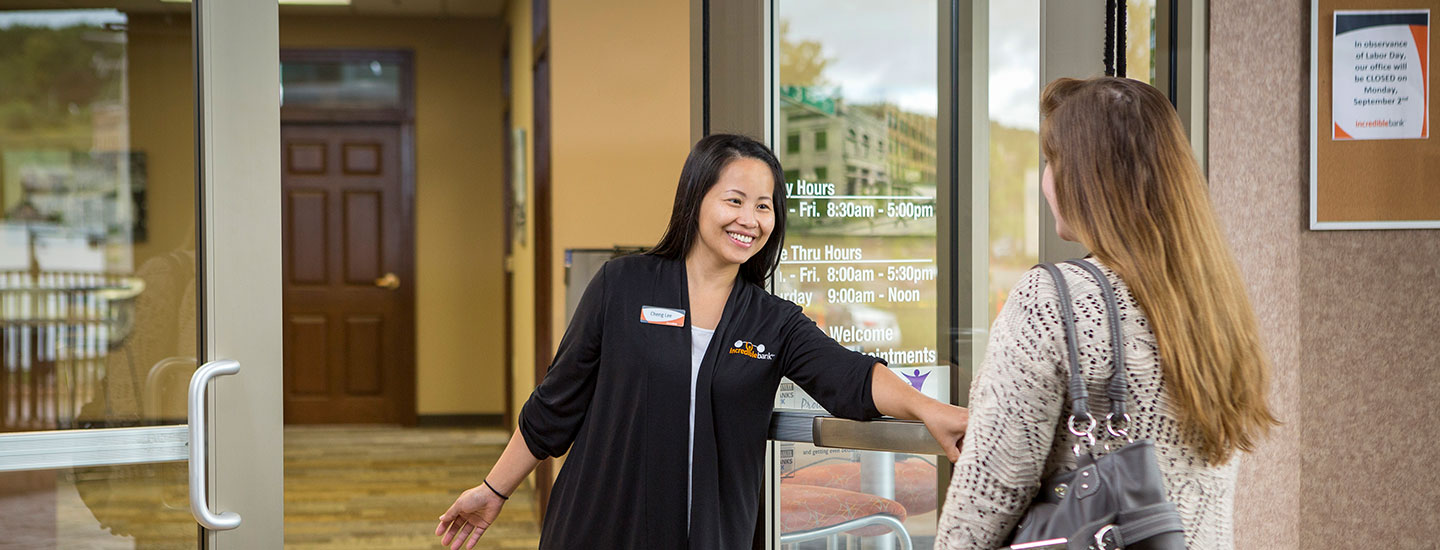IncredibleBank staff opening door for customer