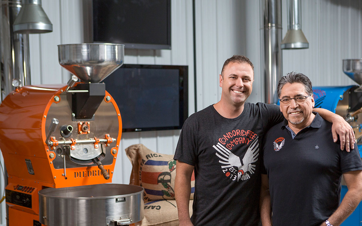 two men working at a coffee roaster