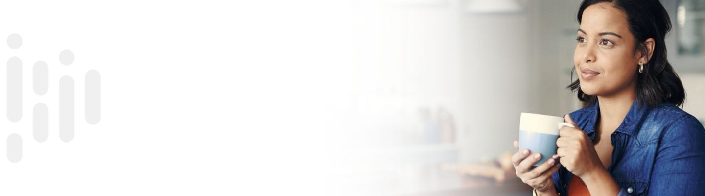 Woman at home holding a coffee mug, representing everyday banking moments.