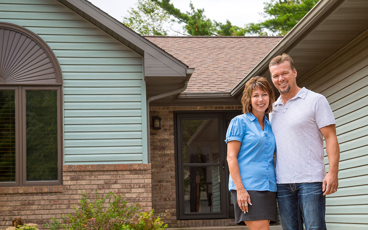 couple in front of their home