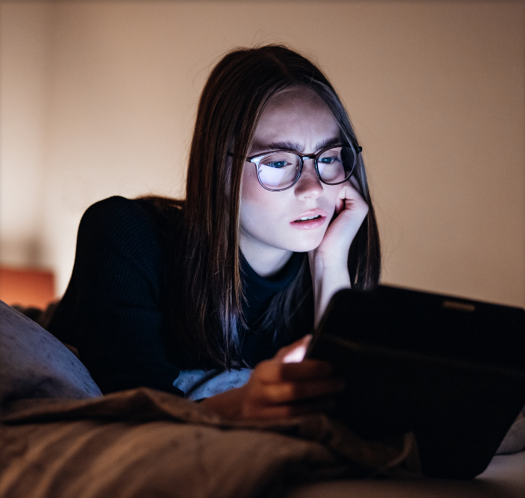 Woman looking at laptop with eyebrows furrowed