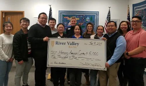 Hmong American Center receiving a donation from IncredibleBank