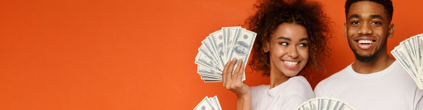 Woman and man holding cash and smiling