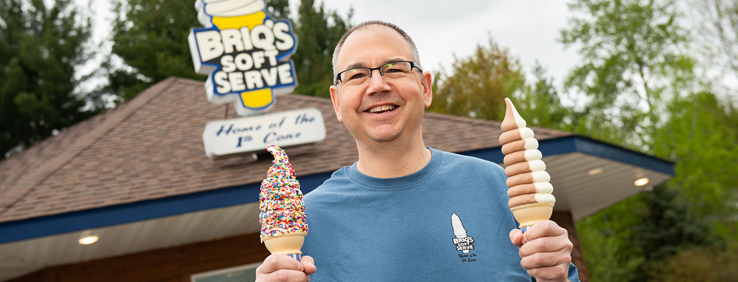 ice cream shop owner with 2 ice cream cones