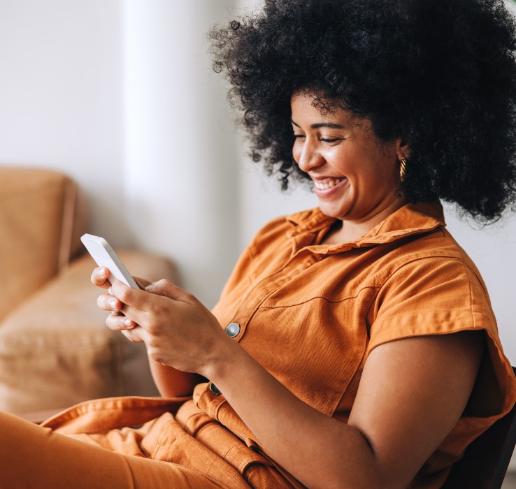 Woman smiling and using smartphone