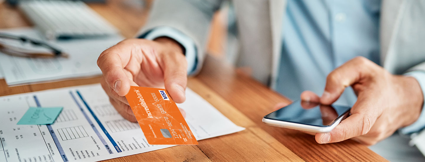 A man using an IncredibleBank Visa Business Card