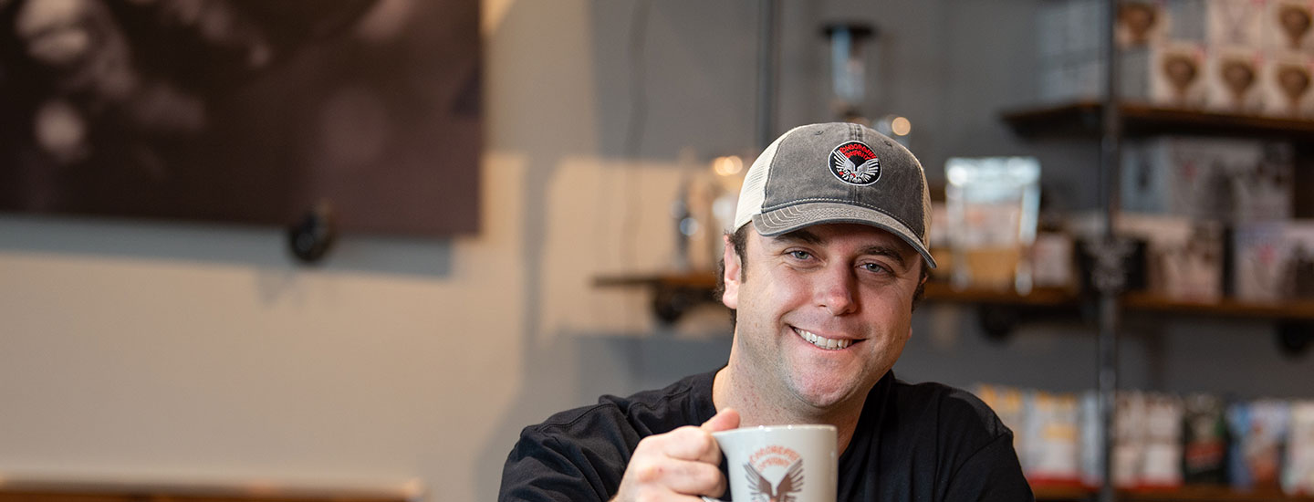 business owner drinking coffee at coffee shop