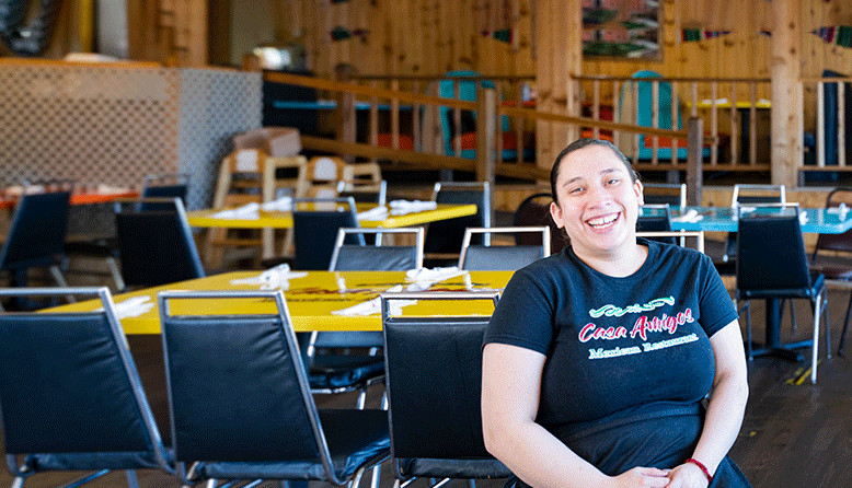 Yareli Guitierrez, co-owner of Casa Amigos Restaurant, smiles in her restaurant.